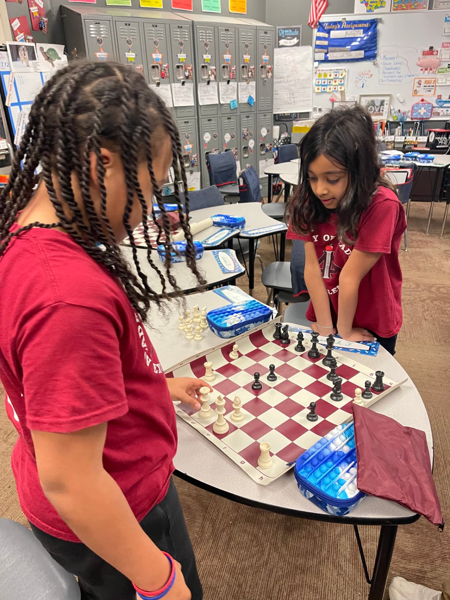 Two students playing chess during chess club