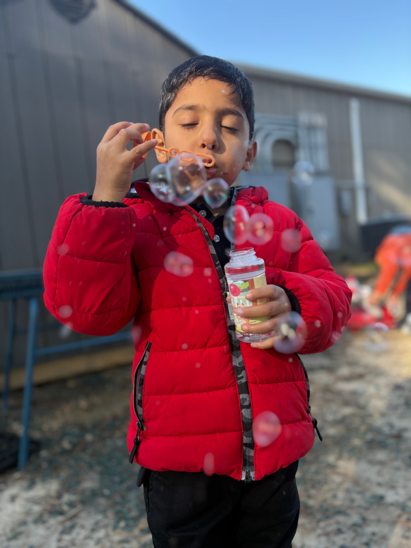 A student blowing bubbles outdoors