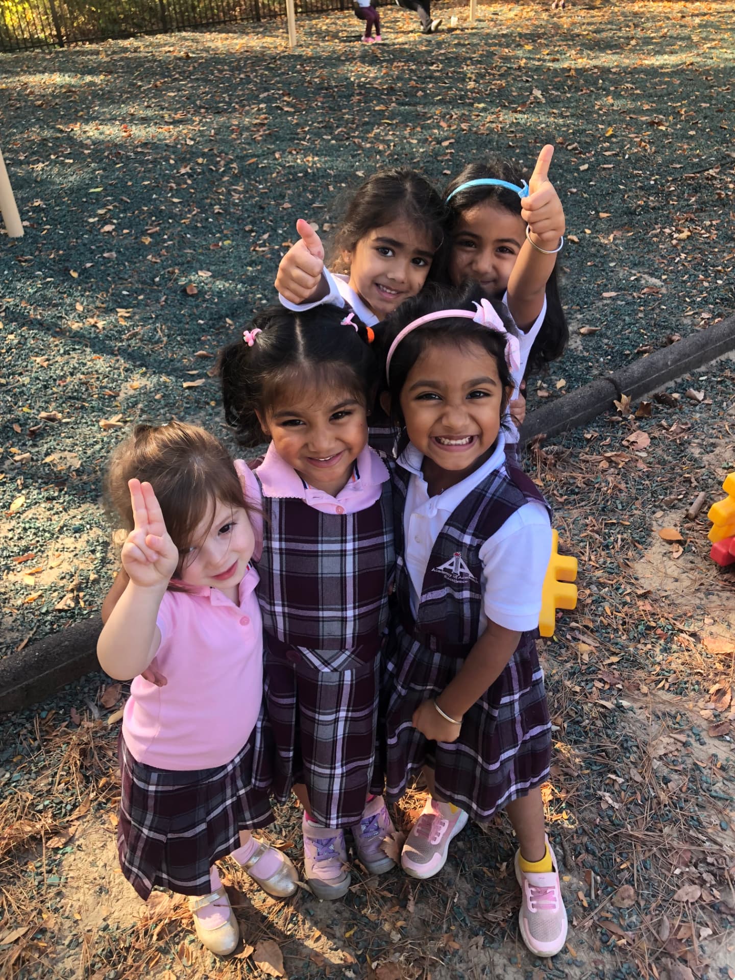Pre-K students smiling on the playground