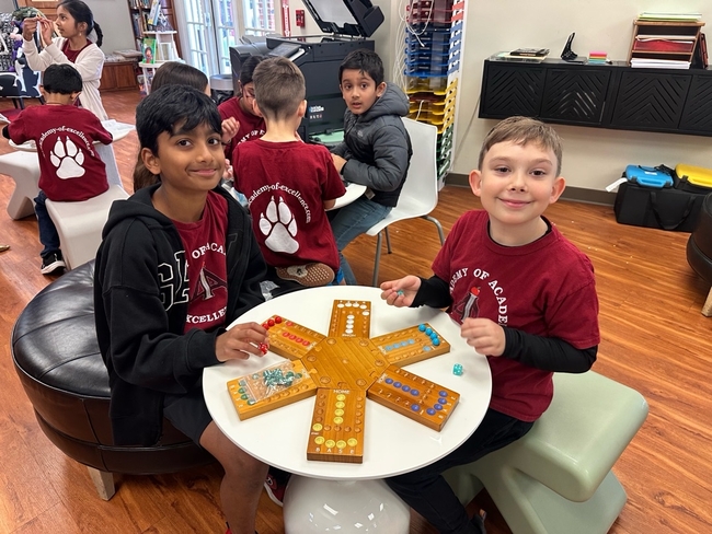 Students playing a board game in the Lemon Tree Lounge